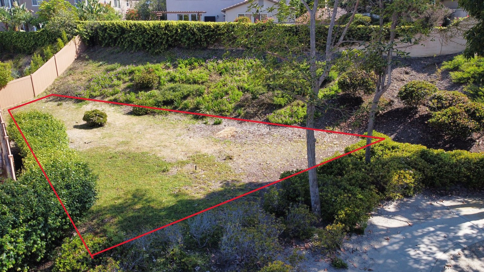 Drone photo of the current garden site with the trapezoidal area outlined in red